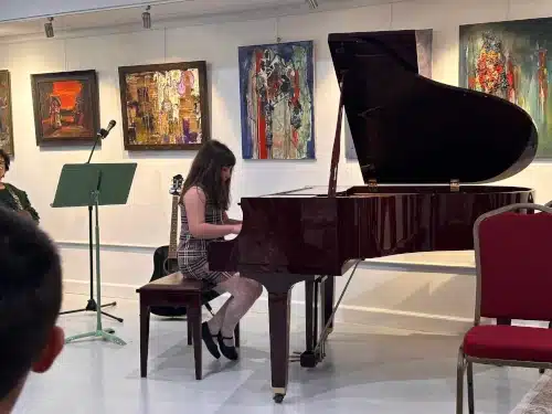 Kid playing piano orchestra music academy